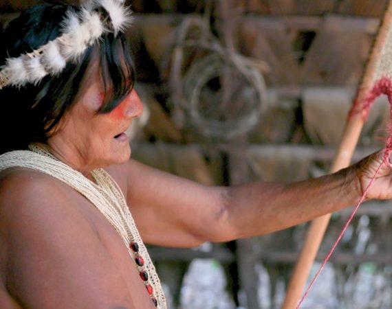 Waorani women creating handcrafted weavings in the Ecuadorian Amazon